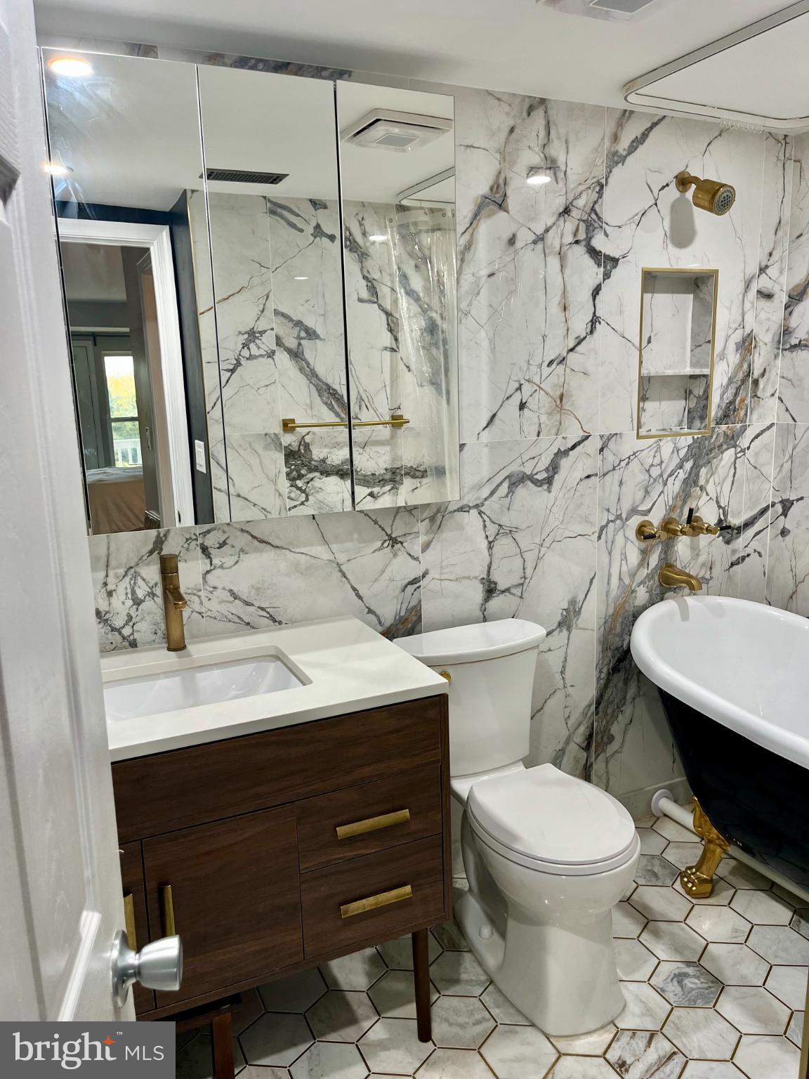 2609 Douglass Road Southeast, Unit 402 Washington, DC 20020 - Photo 22 of 35 a bathroom with a sink mirror vanity and toilet