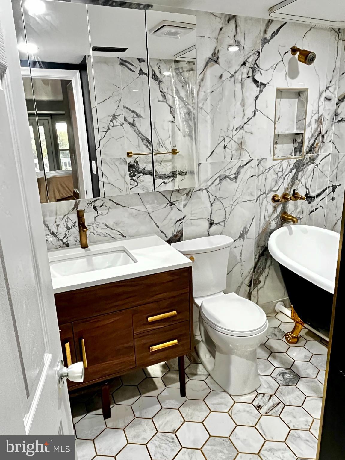 2609 Douglass Road Southeast, Unit 402 Washington, DC 20020 - Photo 23 of 35 a bathroom with a sink toilet and mirror