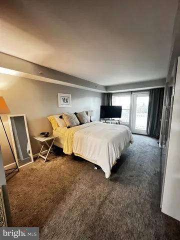 a bedroom with double bed and a window