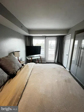 a bedroom with a large bed and a tv