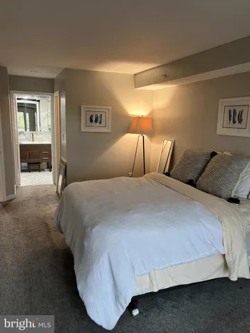 a bedroom with a bed and lamp