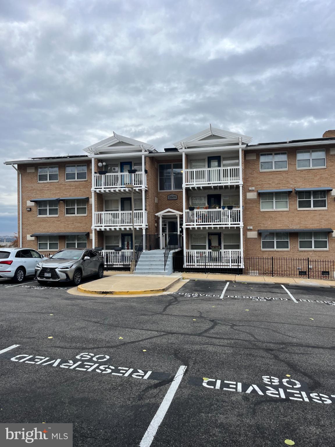 2609 Douglass Road Southeast, Unit 402 Washington, DC 20020 - Photo 35 of 35 a front view of a building with streets and trees