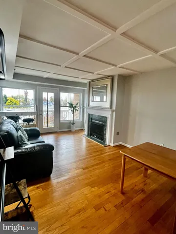 a living room with fireplace furniture and a floor to ceiling window