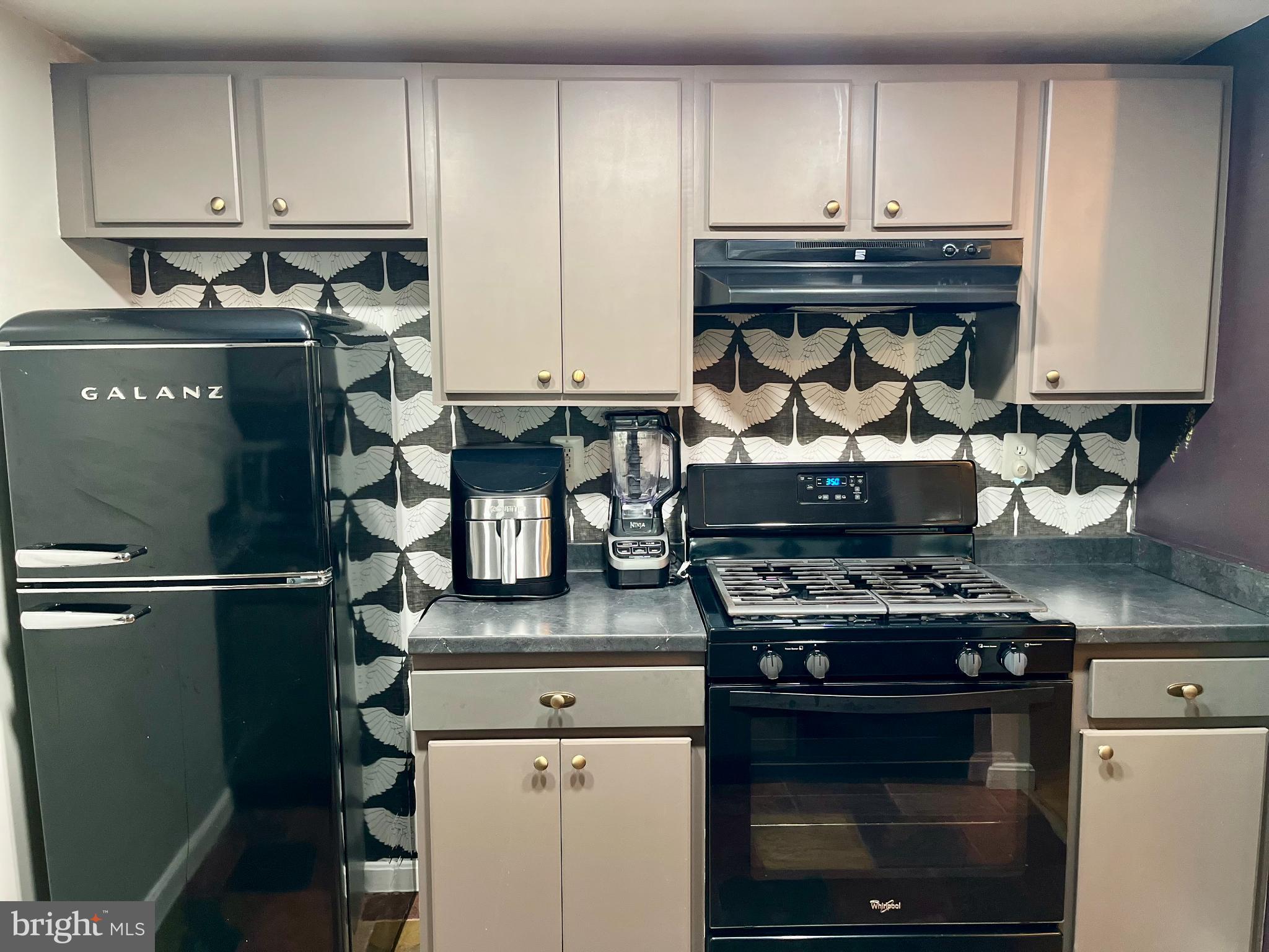 2609 Douglass Road Southeast, Unit 402 Washington, DC 20020 - Photo 9 of 35 a kitchen with a stove and a refrigerator