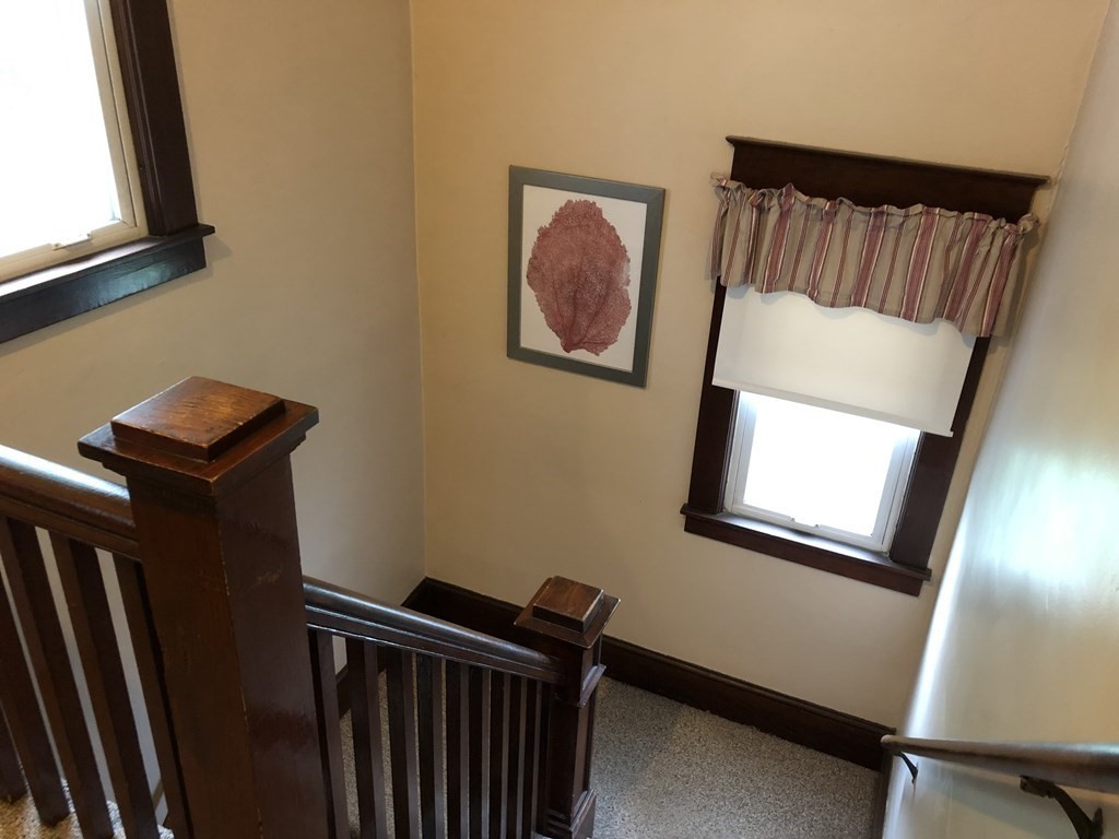 23 Acton Street Springfield, MA 01151 - Photo 16 of 33 a view of a hallway with wooden floor and a window