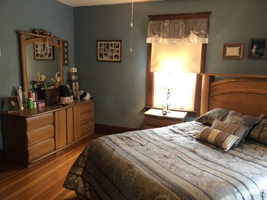 23 Acton Street Springfield, MA 01151 - Photo 18 of 33 a bedroom with a bed and a dresser