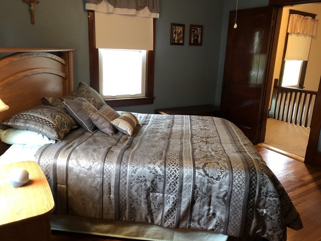 23 Acton Street Springfield, MA 01151 - Photo 20 of 33 a bedroom with a bed and a chandelier