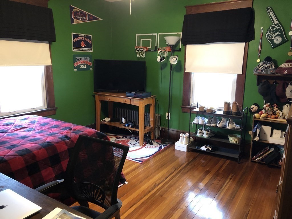 23 Acton Street Springfield, MA 01151 - Photo 22 of 33 a bedroom with a bed and a fireplace