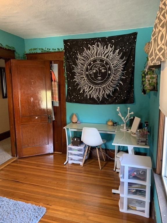 23 Acton Street Springfield, MA 01151 - Photo 23 of 33 a room with furniture and wooden floor