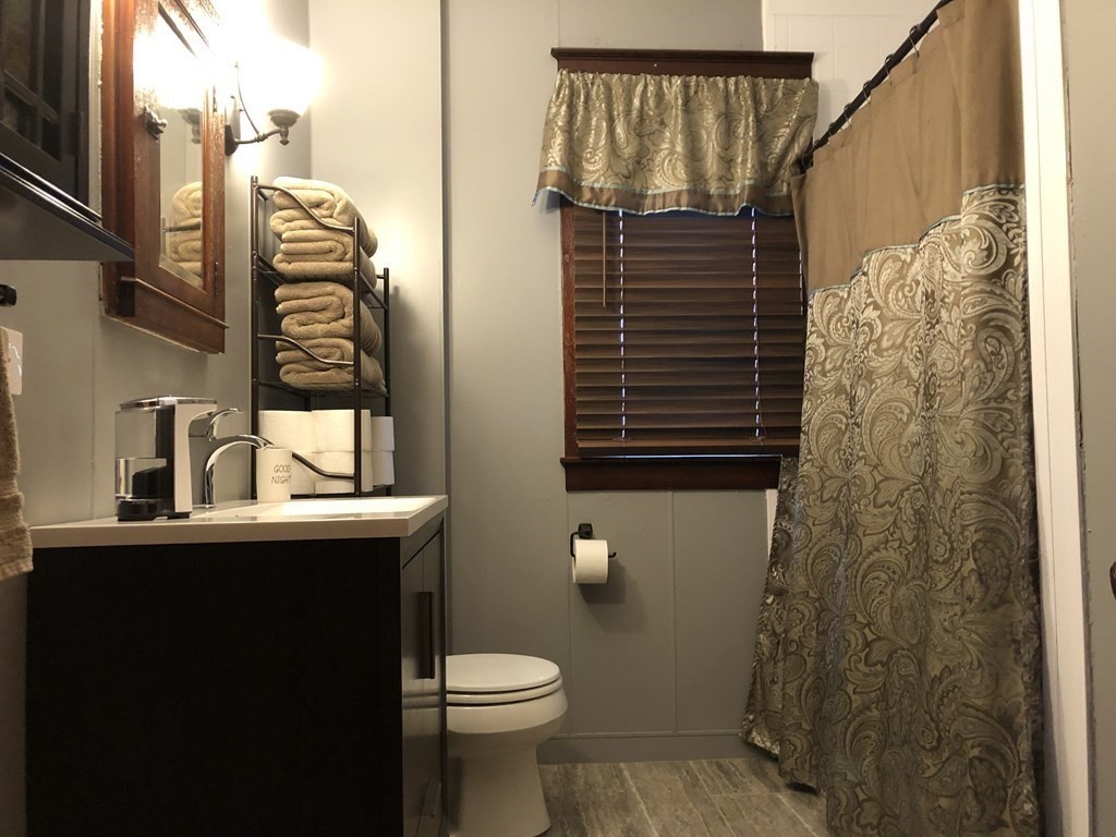 23 Acton Street Springfield, MA 01151 - Photo 26 of 33 a bathroom with a sink a toilet and shower