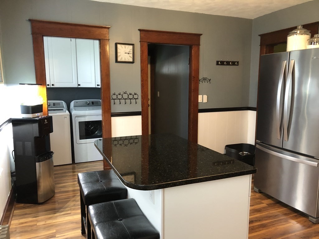23 Acton Street Springfield, MA 01151 - Photo 7 of 33 a kitchen with a refrigerator and a stove top oven