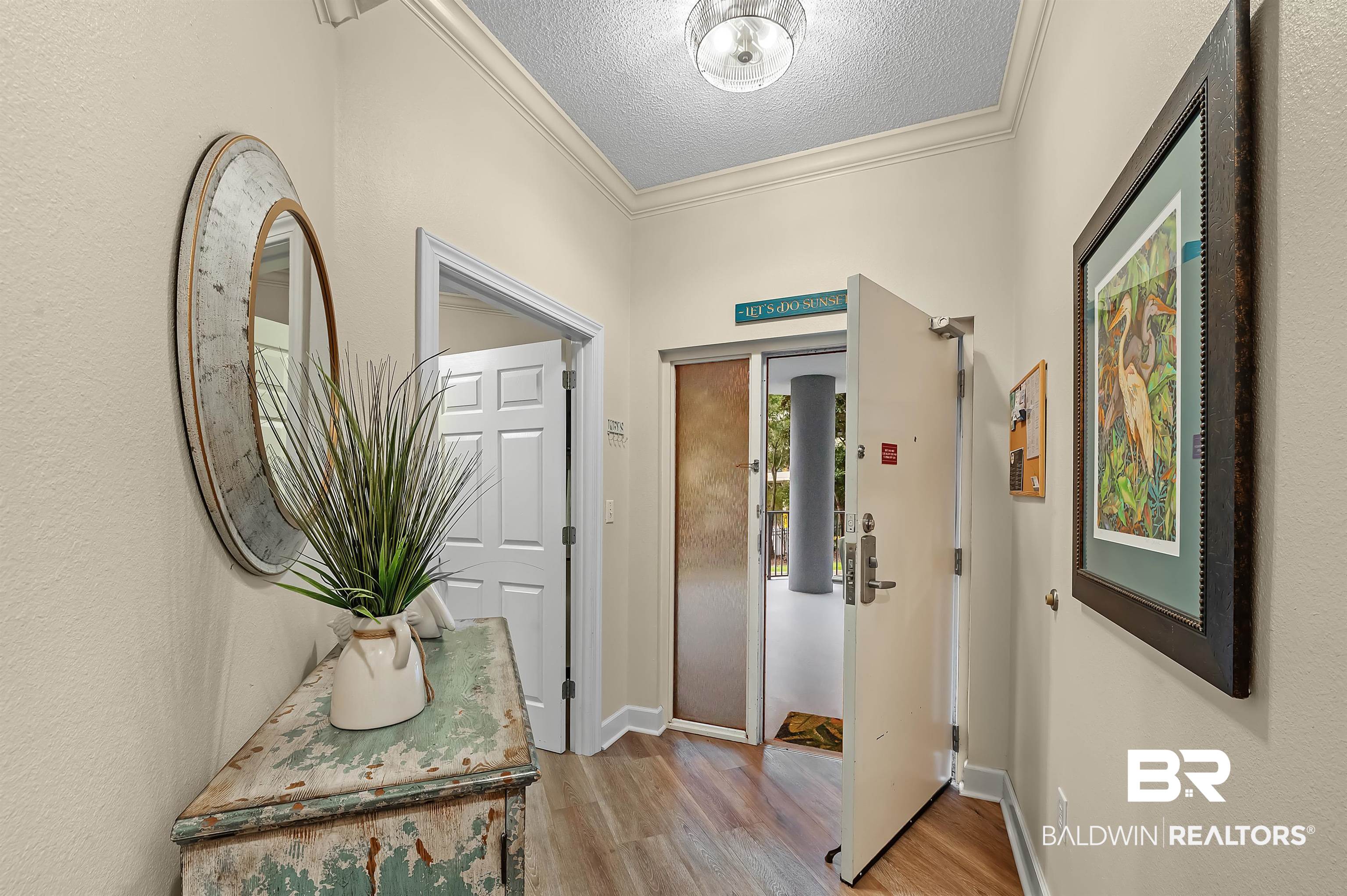 27582 Canal Road, Unit 2104 Orange Beach, AL 36561 - Photo 35 of 35 Corridor with a textured ceiling, light wood-type flooring, and ornamental molding