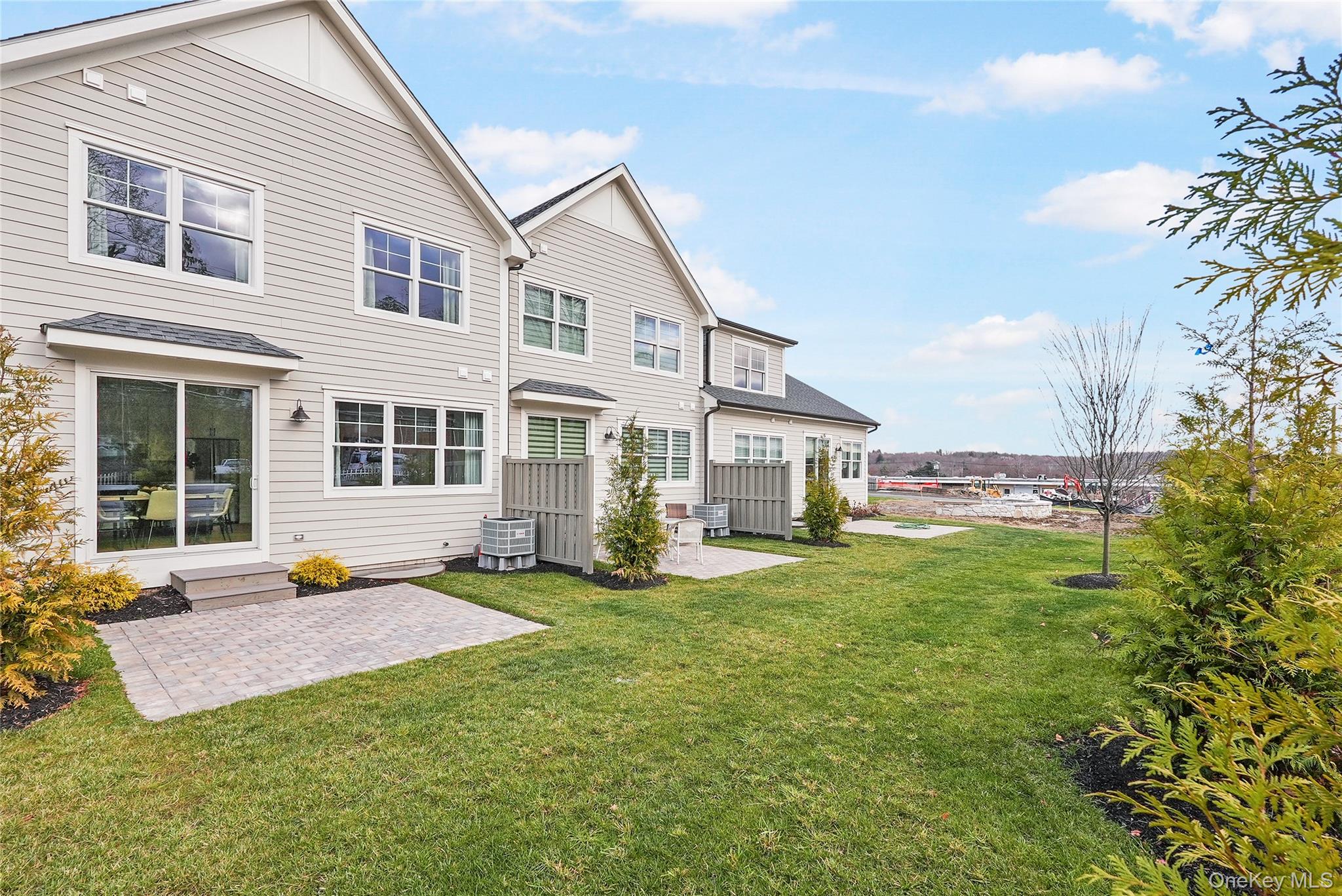2040 Crompond Road, Unit 22 Yorktown Heights, NY 10598 - Photo 19 of 19 Rear view of house with a yard, central AC unit, and a patio