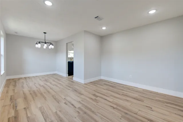 a view of a kitchen with a sink and wooden floor