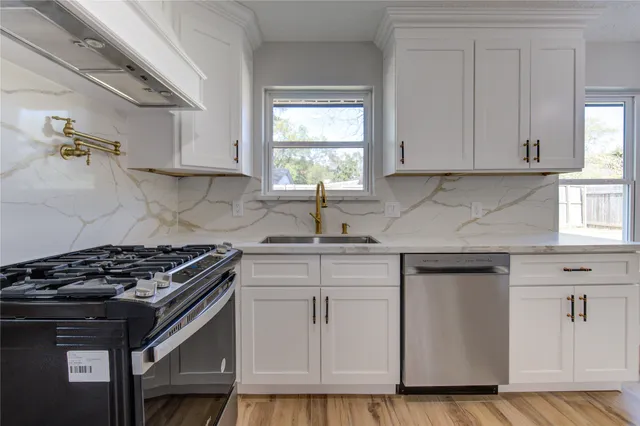 a view of empty room with wooden floor chandelier and fireplace