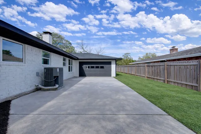 a kitchen with stainless steel appliances a table and chairs in it