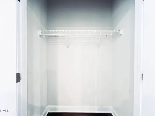 a kitchen with stainless steel appliances granite countertop a sink a stove a refrigerator a microwave and white cabinets
