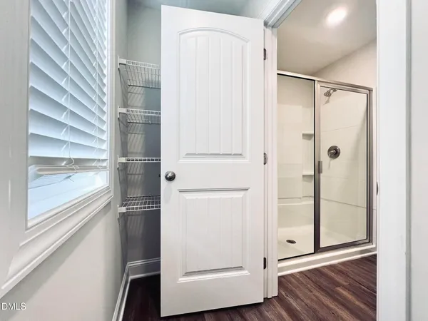 a bathroom with a shower and a glass door