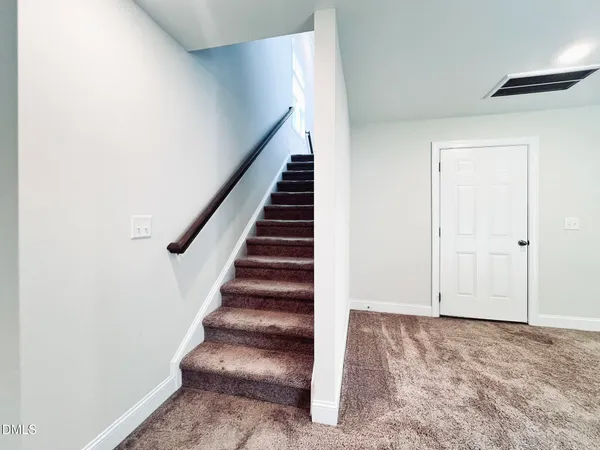 an empty room with closet and windows