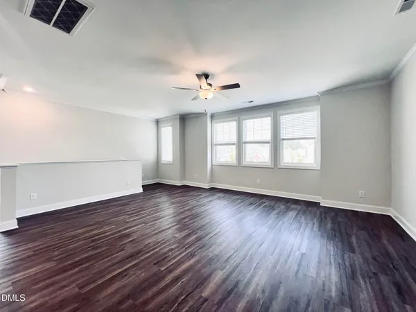 a kitchen with stainless steel appliances a refrigerator and wooden floor