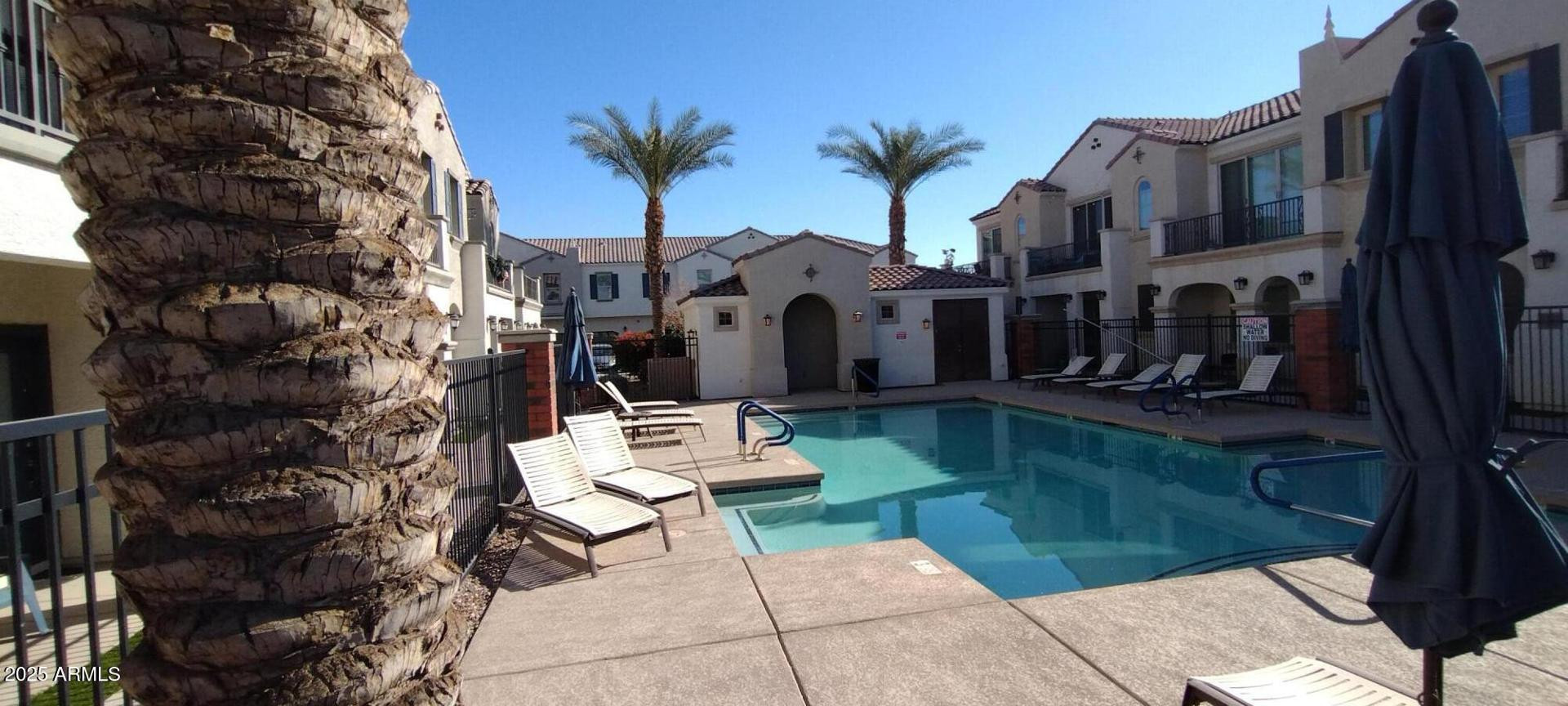 4038 East Erie Street, Unit 101 Gilbert, AZ 85295 - Photo 7 of 7 a view of a patio with couches table and chairs and potted plants