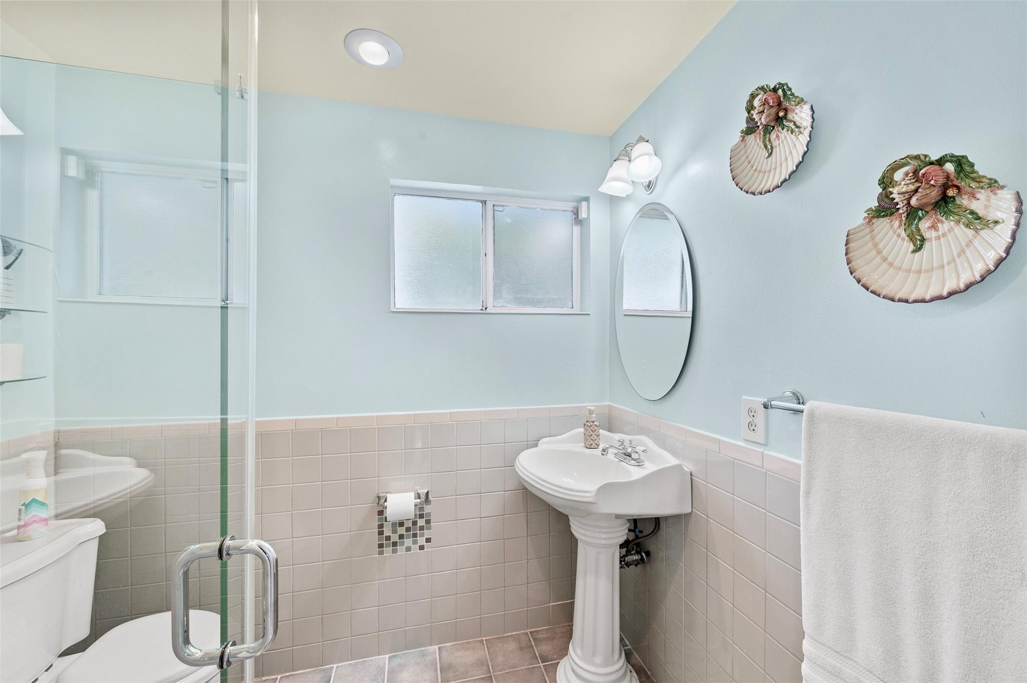 946 Alamanda Road West Palm Beach, FL 33405 - Photo 11 of 56 a bathroom with a sink a toilet and a mirror