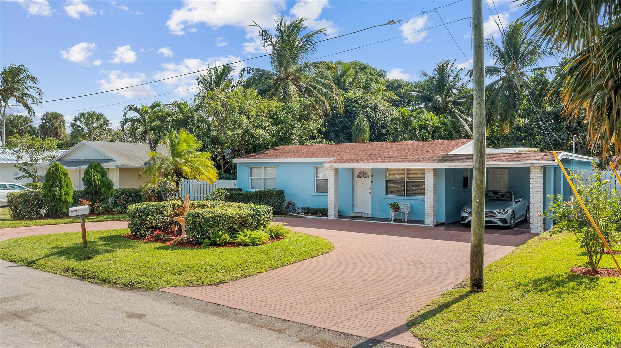 946 Alamanda Road West Palm Beach, FL 33405 - Photo 24 of 56 a front view of a house with a garden and patio
