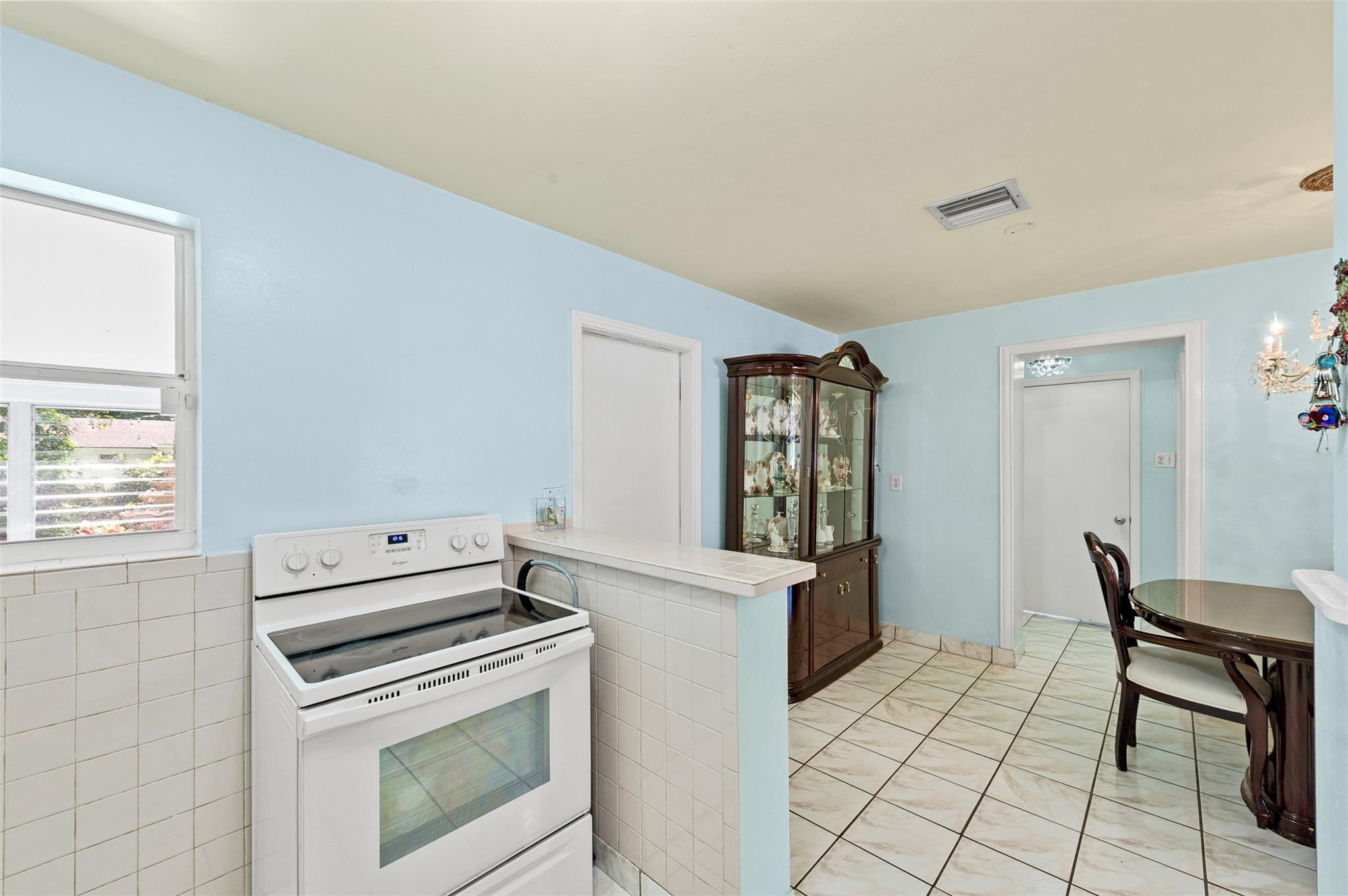 946 Alamanda Road West Palm Beach, FL 33405 - Photo 41 of 56 a kitchen with a stove and a refrigerator