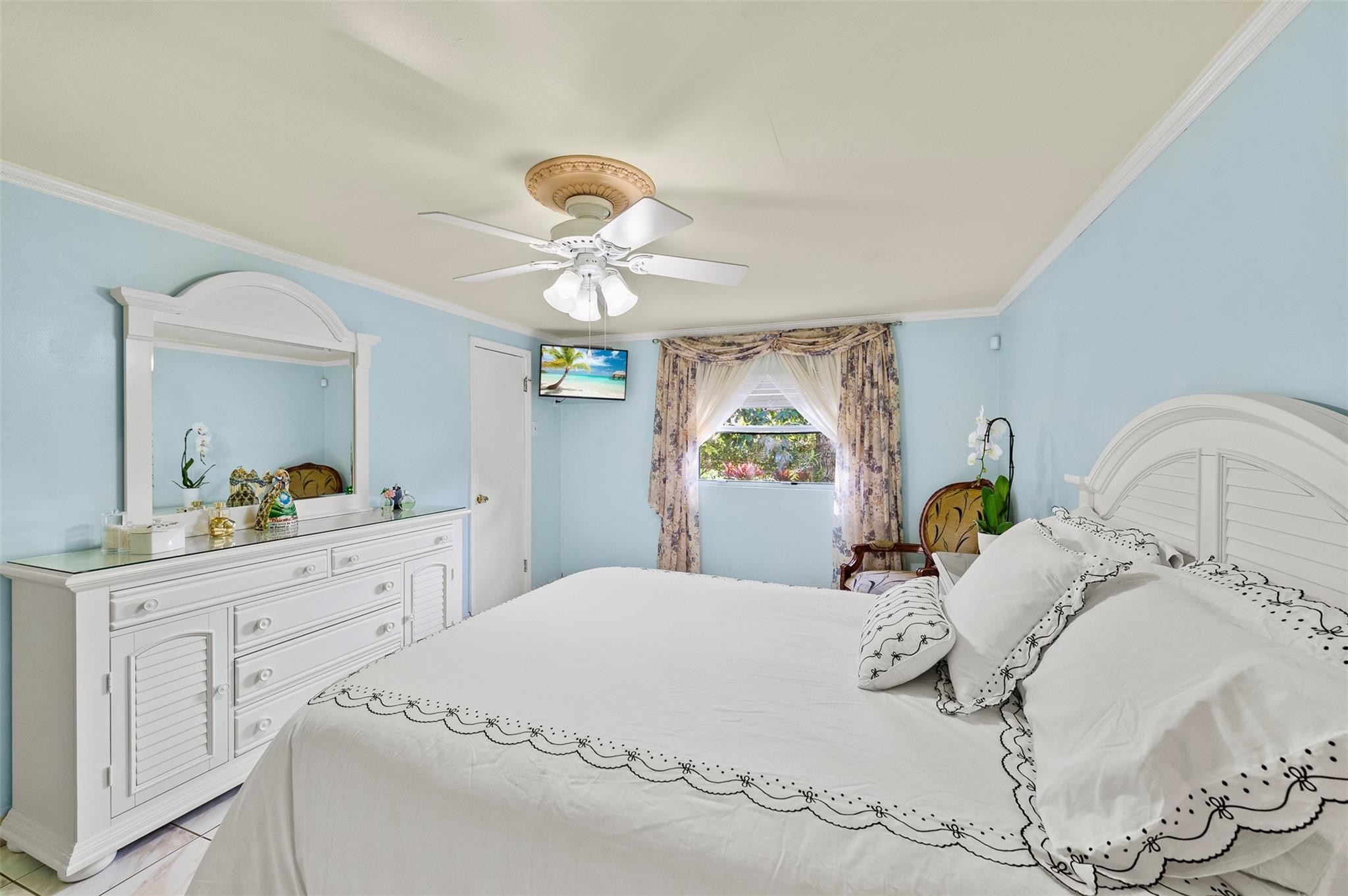 946 Alamanda Road West Palm Beach, FL 33405 - Photo 43 of 56 a bedroom with a bed and a chandelier