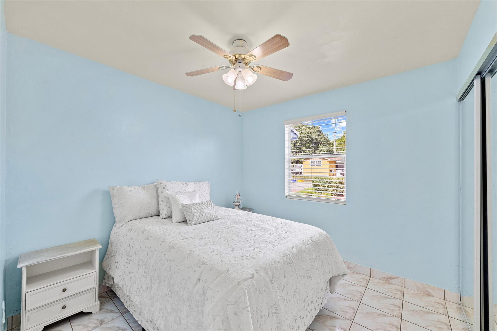 946 Alamanda Road West Palm Beach, FL 33405 - Photo 45 of 56 a bedroom with a large bed and a window