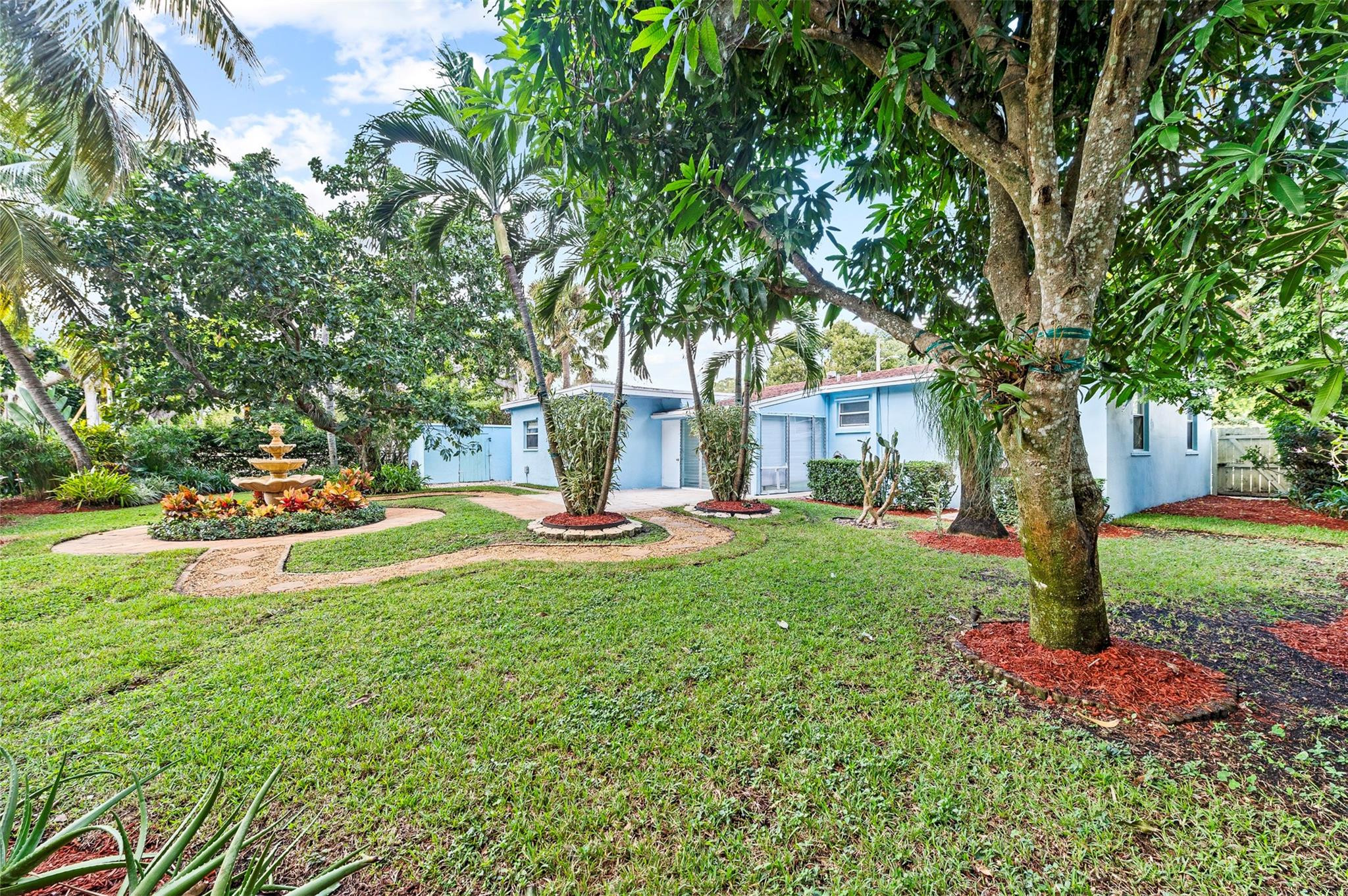 946 Alamanda Road West Palm Beach, FL 33405 - Photo 51 of 56 a view of a garden with a fountain