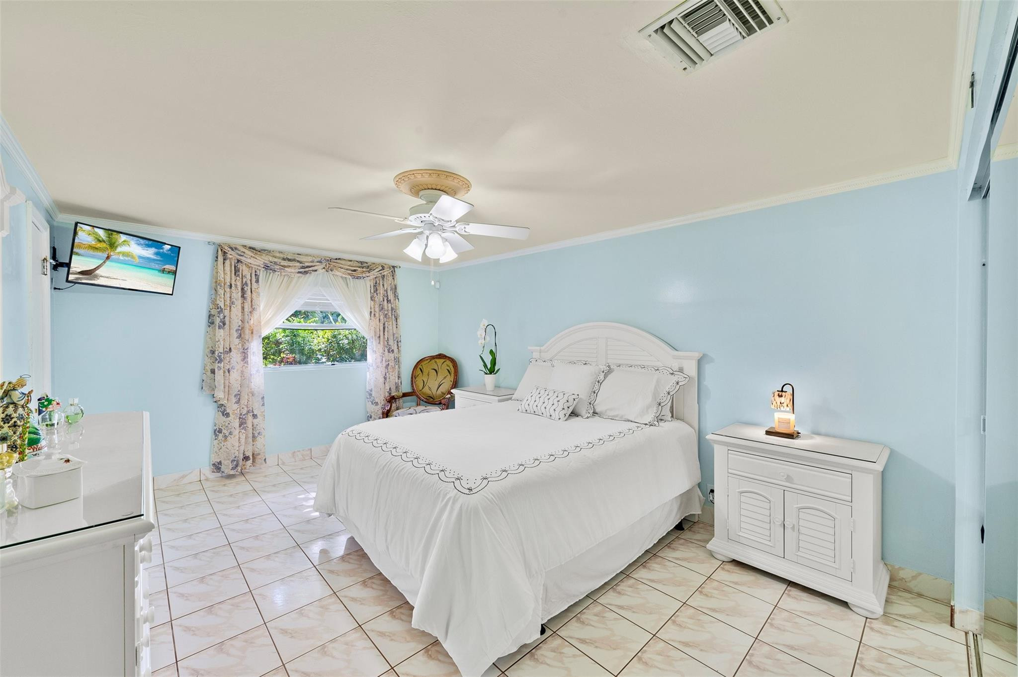 946 Alamanda Road West Palm Beach, FL 33405 - Photo 10 of 56 a spacious bedroom with a bed and a chandelier
