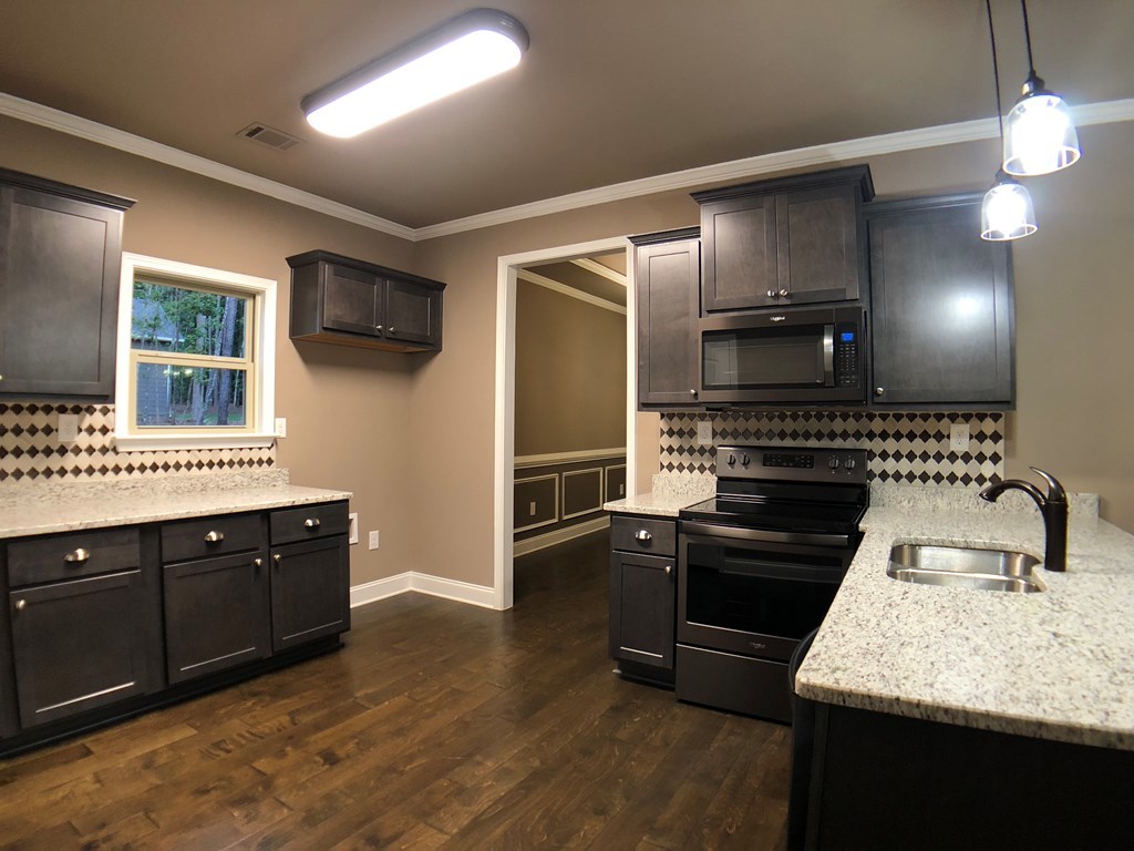330 Walnut Grove Road Gray, GA 31032 - Photo 11 of 42 a kitchen with granite countertop stainless steel appliances and wooden cabinets