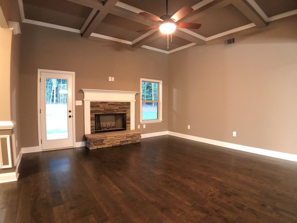 330 Walnut Grove Road Gray, GA 31032 - Photo 13 of 42 a view of an empty room with wooden floor fireplace and a window