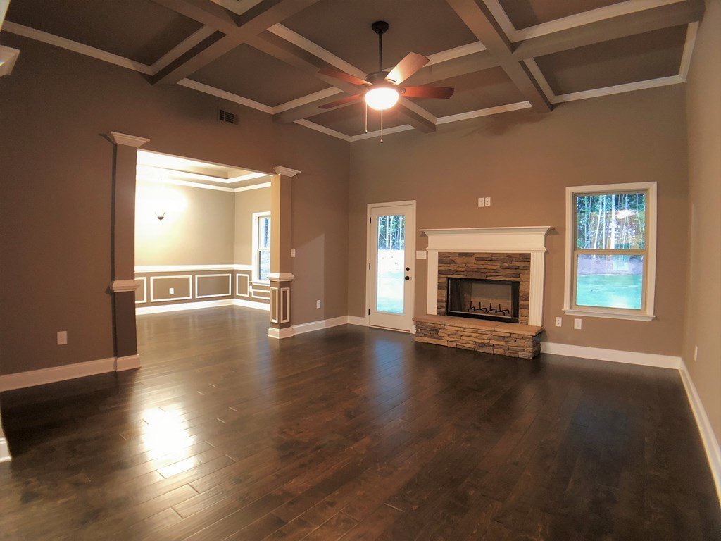 330 Walnut Grove Road Gray, GA 31032 - Photo 14 of 42 an empty room with wooden floor fireplace and windows