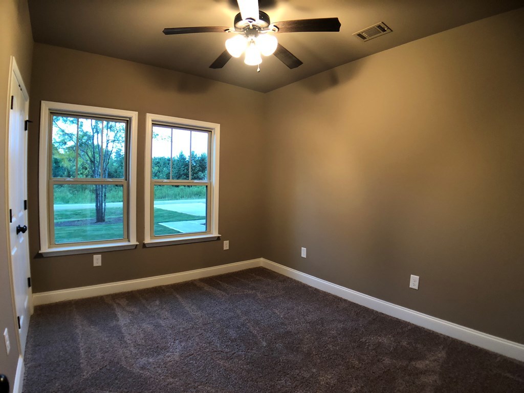 330 Walnut Grove Road Gray, GA 31032 - Photo 23 of 42 an empty room with a window and a fan