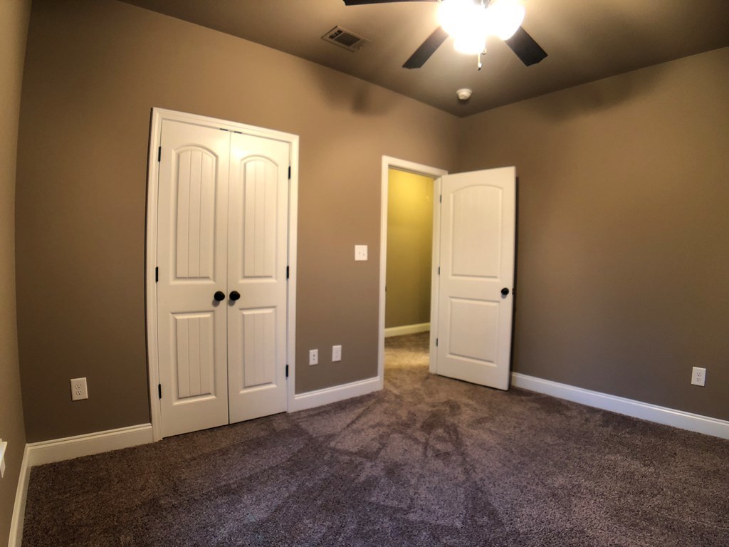 330 Walnut Grove Road Gray, GA 31032 - Photo 29 of 42 an empty room with closet and a chandelier fan