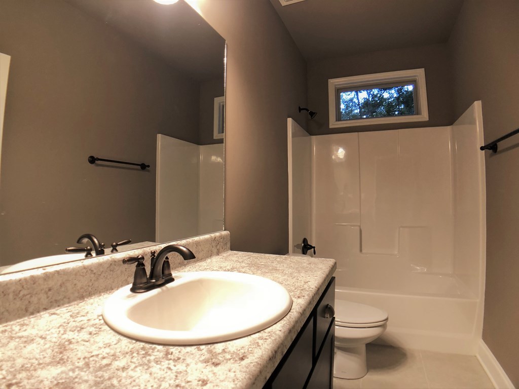 330 Walnut Grove Road Gray, GA 31032 - Photo 32 of 42 a bathroom with a sink a toilet and shower