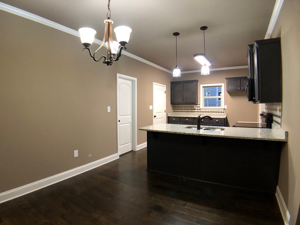 330 Walnut Grove Road Gray, GA 31032 - Photo 6 of 42 a kitchen with a sink chandelier and wooden floor