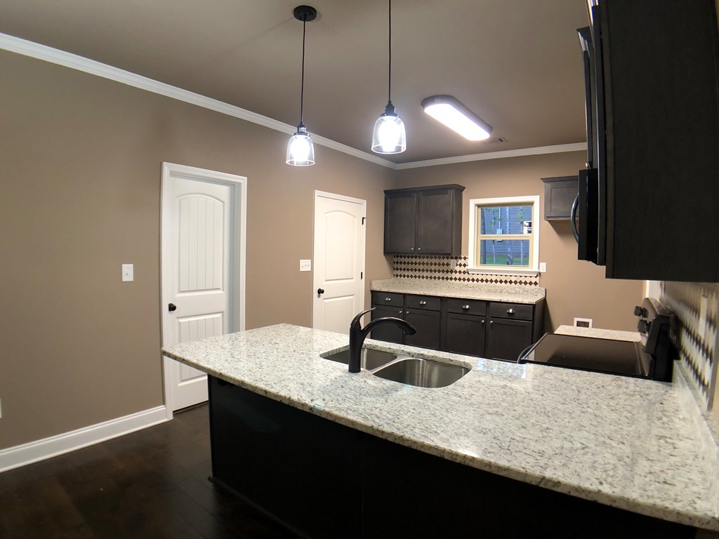 330 Walnut Grove Road Gray, GA 31032 - Photo 8 of 42 a kitchen with a sink a center island and wooden floor
