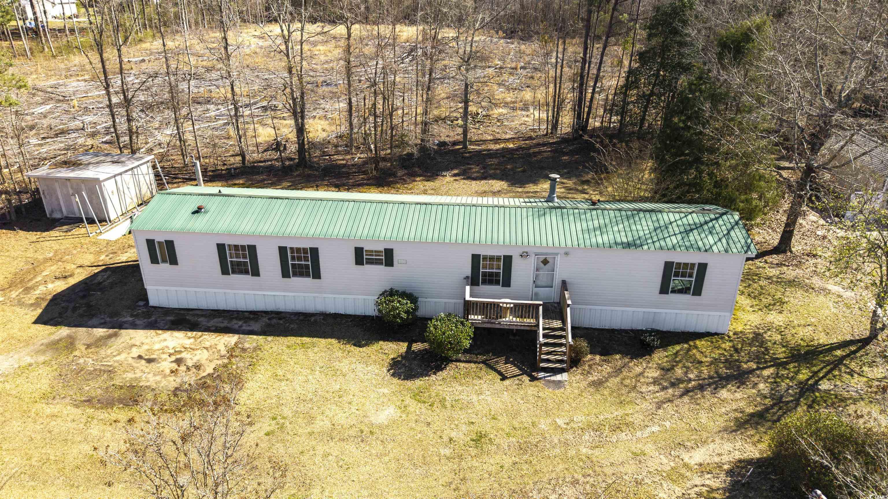 4535 Old Tram Road Conway, SC 29527 - Photo 3 of 36 View of front of property with an outdoor structure, a storage shed, stairs, and metal roof