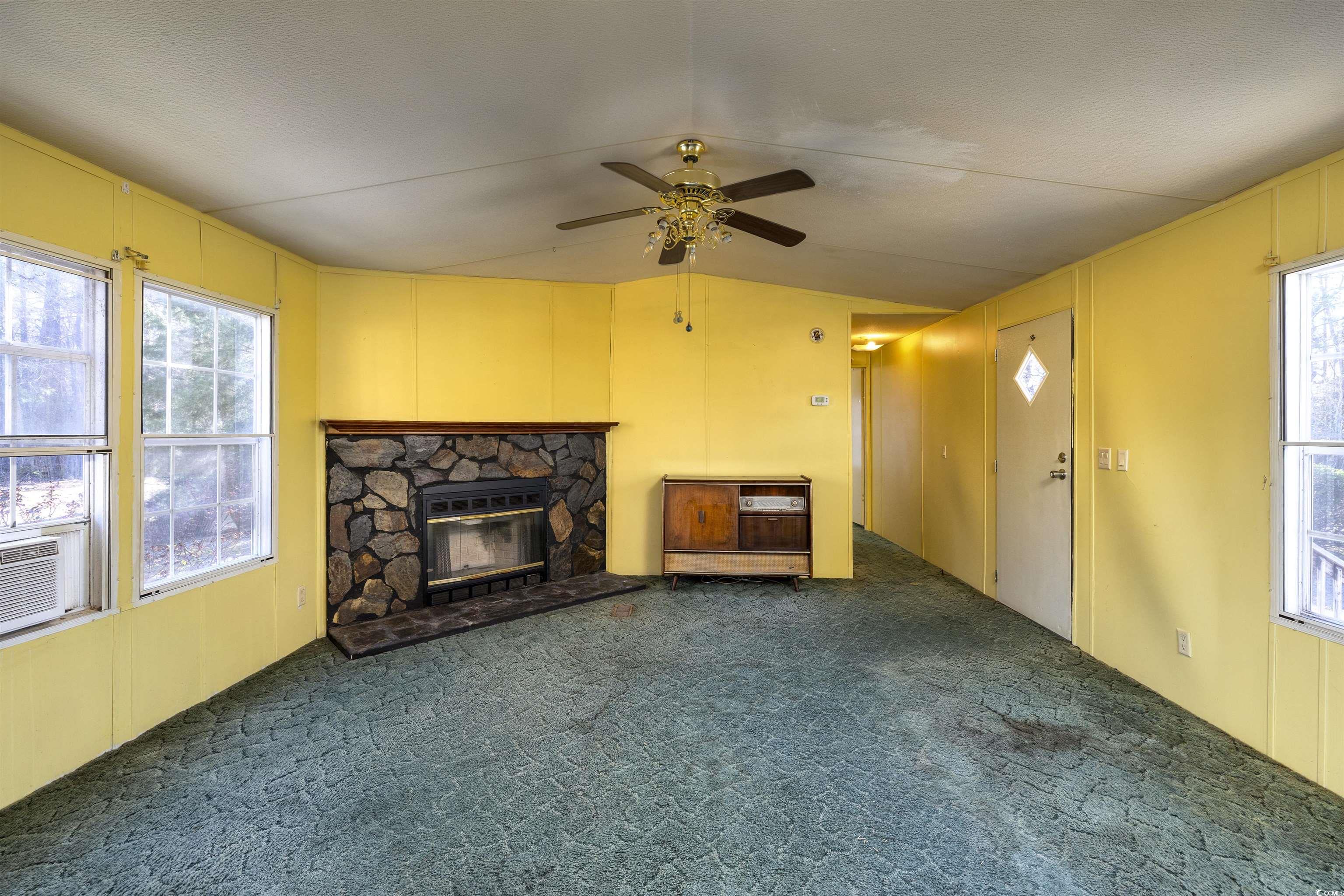 4535 Old Tram Road Conway, SC 29527 - Photo 5 of 36 Unfurnished living room featuring a wealth of natural light, ceiling fan, lofted ceiling, and carpet floors
