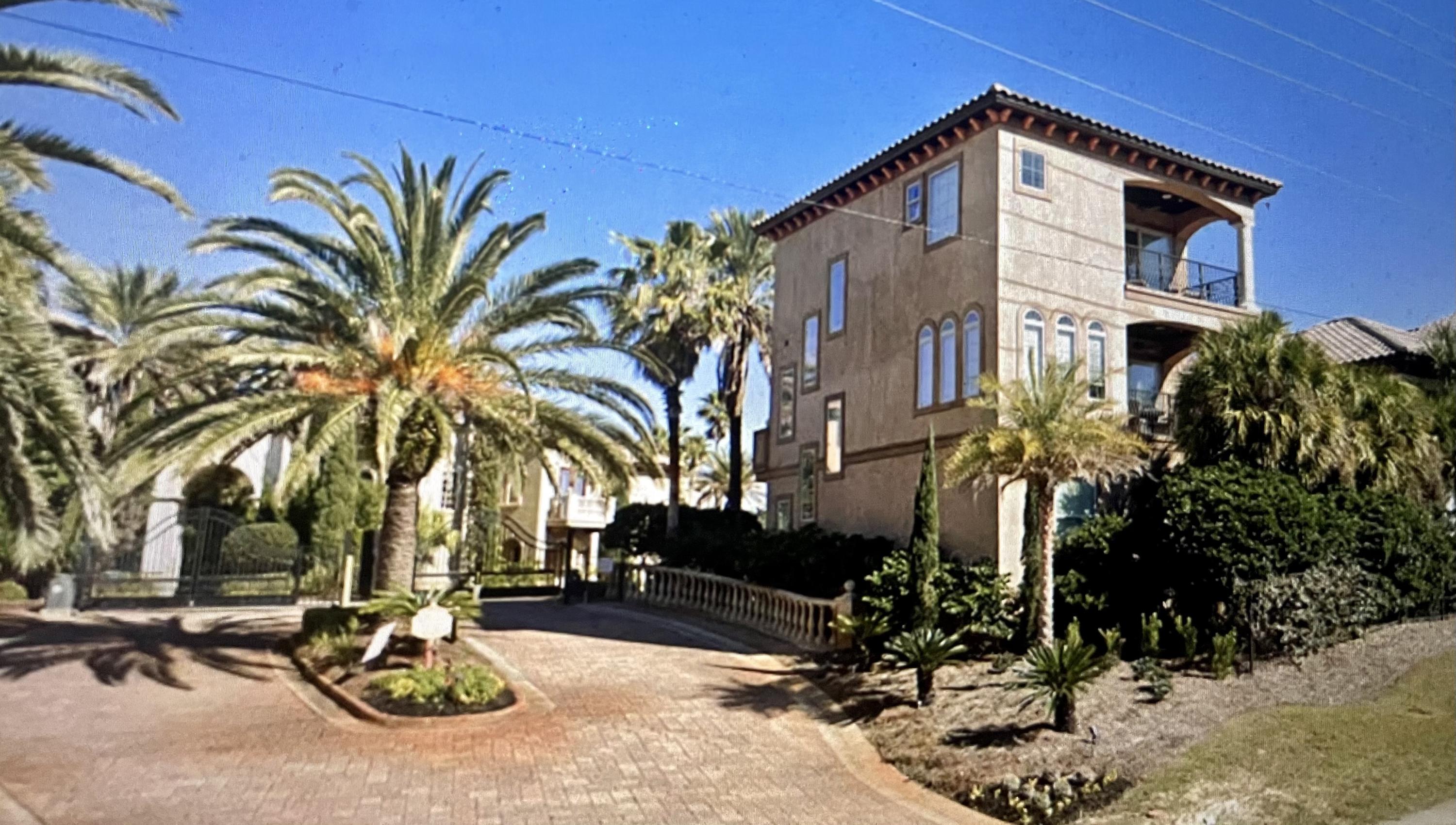 a front view of a house with a tree
