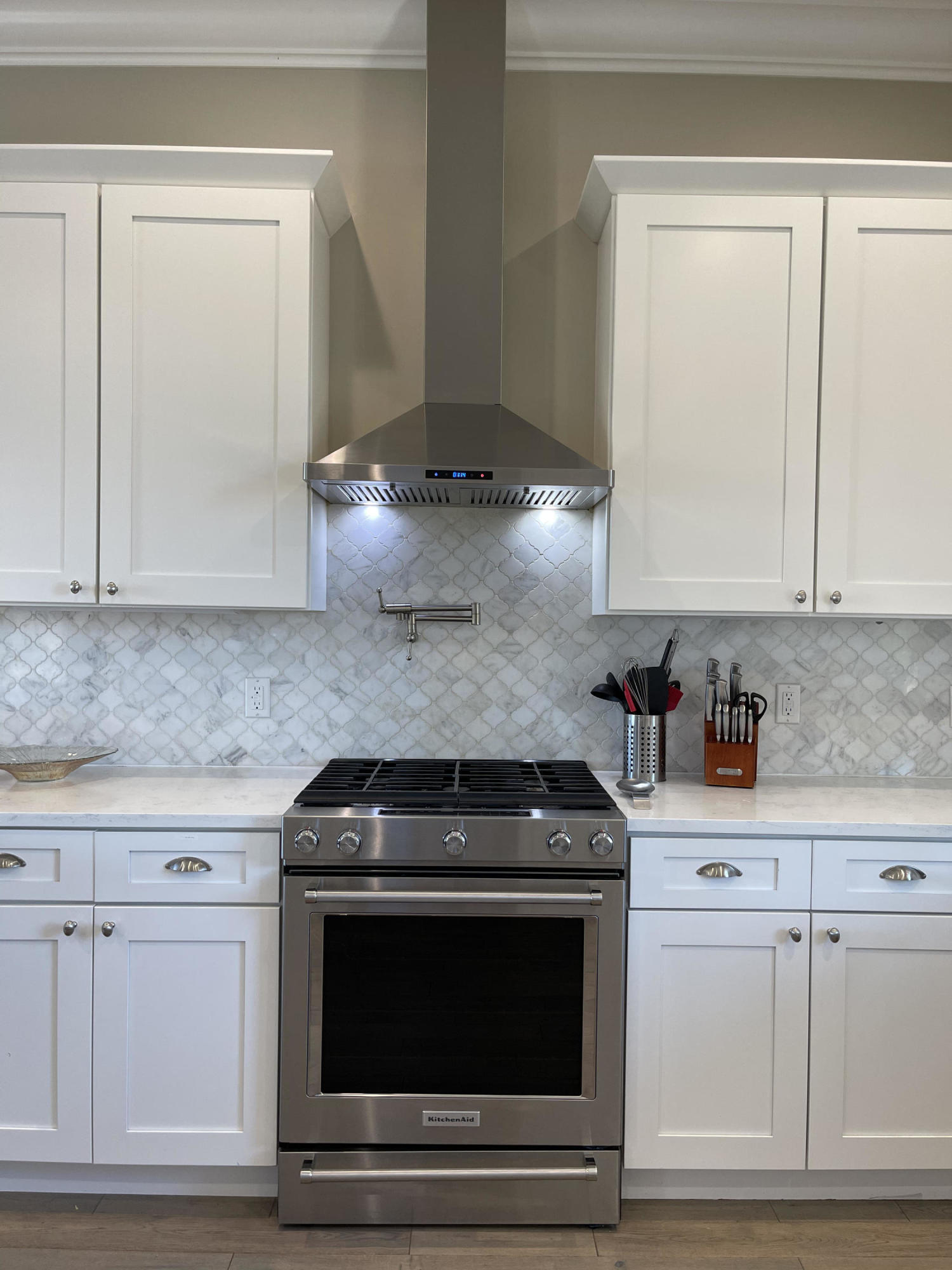 231 Rue St Tropez Miramar Beach, FL 32550 - Photo 11 of 26 a kitchen with white cabinets and appliances