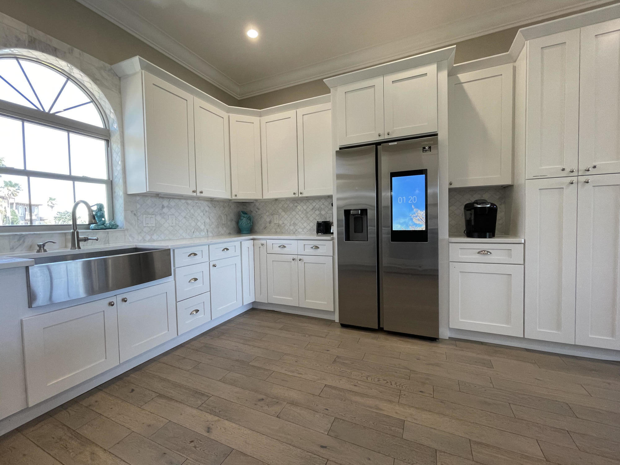 231 Rue St Tropez Miramar Beach, FL 32550 - Photo 12 of 26 a kitchen with white cabinets and white appliances