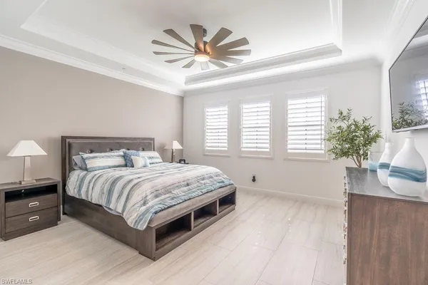 a bedroom with a large bed and a large window