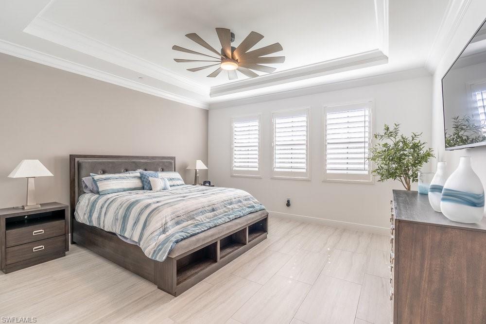 16364 Viansa Way, Unit 202 Naples, FL 34110 - Photo 12 of 39 a bedroom with a large bed and a large window