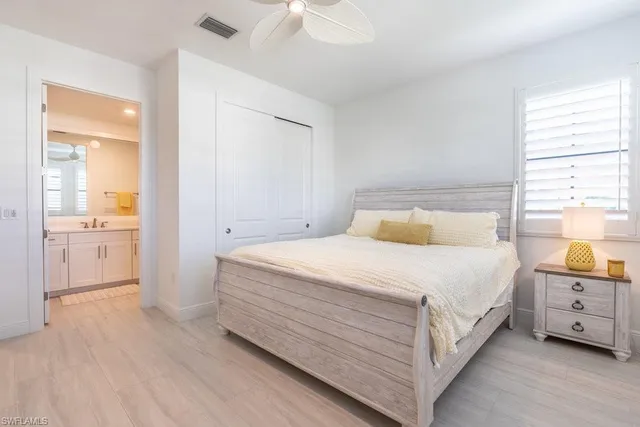 a bedroom with a bed and a view of kitchen