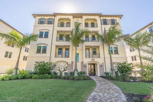a front view of a residential apartment building with a yard