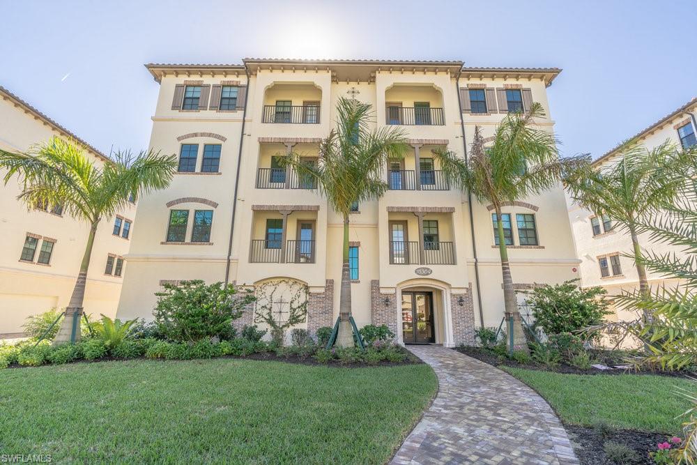 16364 Viansa Way, Unit 202 Naples, FL 34110 - Photo 2 of 39 a front view of a residential apartment building with a yard